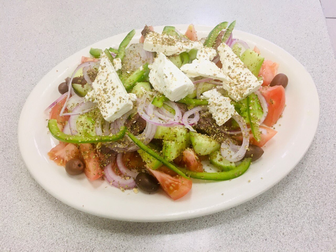 Pictured above is the original Greek salad which comes with tomatoes, cucumbers, feta cheese, olives, pepper, onions, and anchovies ($9.95)