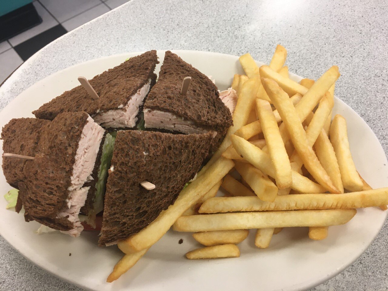 Pictured above is our classic turkey club on rye bread served with a side of fries ($9.95)